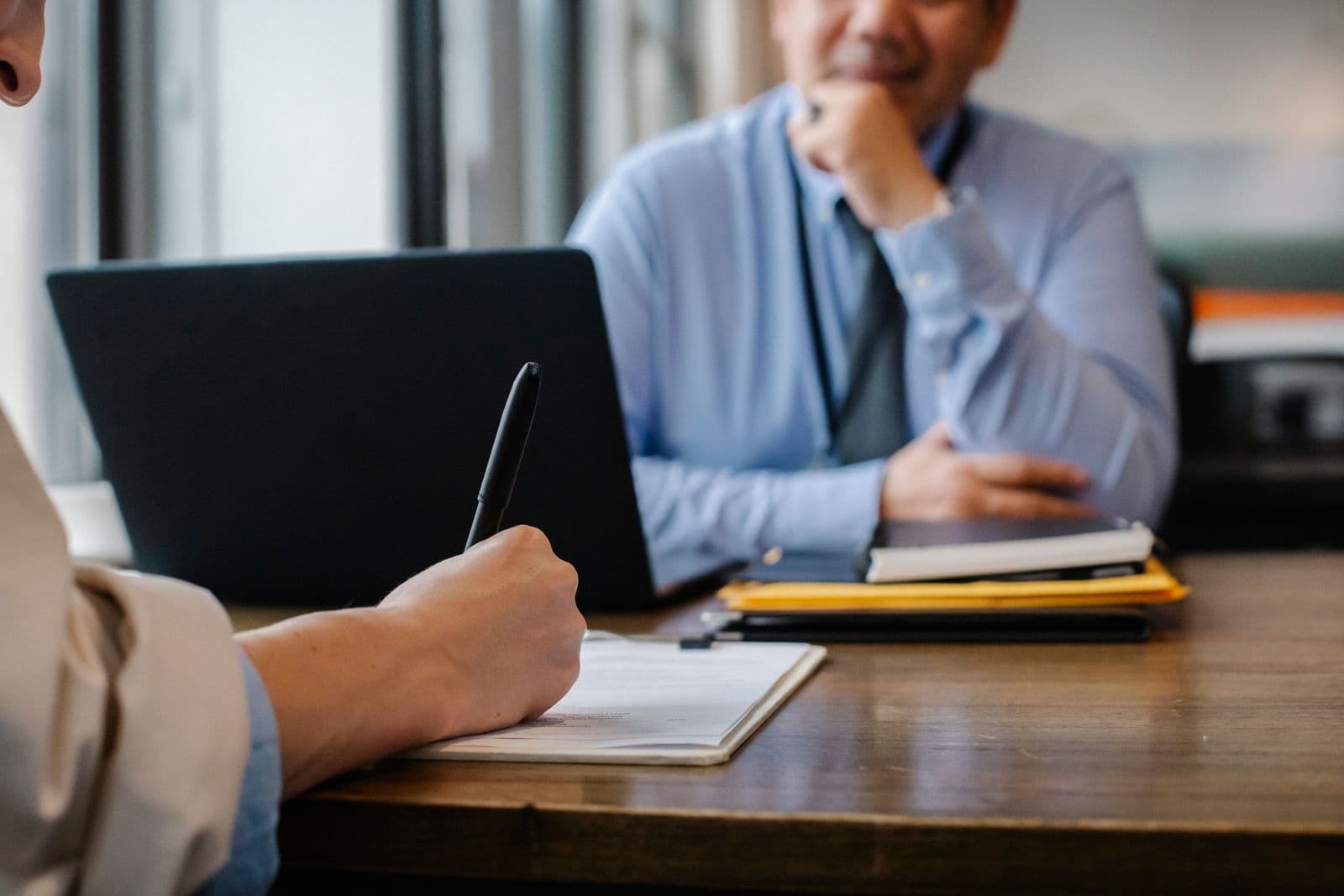 A licensed agent reviewing coverage paperwork with a client at a desk